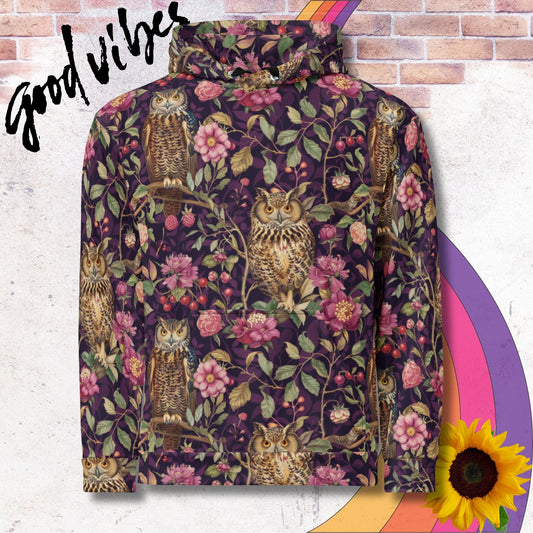 All over print unisex hoodie. Pattern of owls in a purple woodland surrounded by vines and pink flowers
