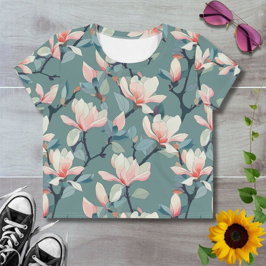 Women's all over print cropped t-shirt. white and pink floral pattern against pale green background