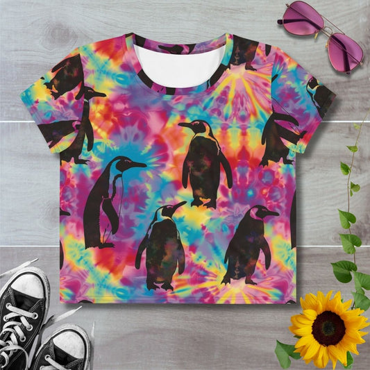 Women's all over print cropped t-shirt. Rainbow tie dye with black silhouette of emperor penguins