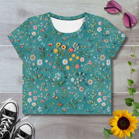 Women's all over print cropped t-shirt. Embroidered style flowers on light green background