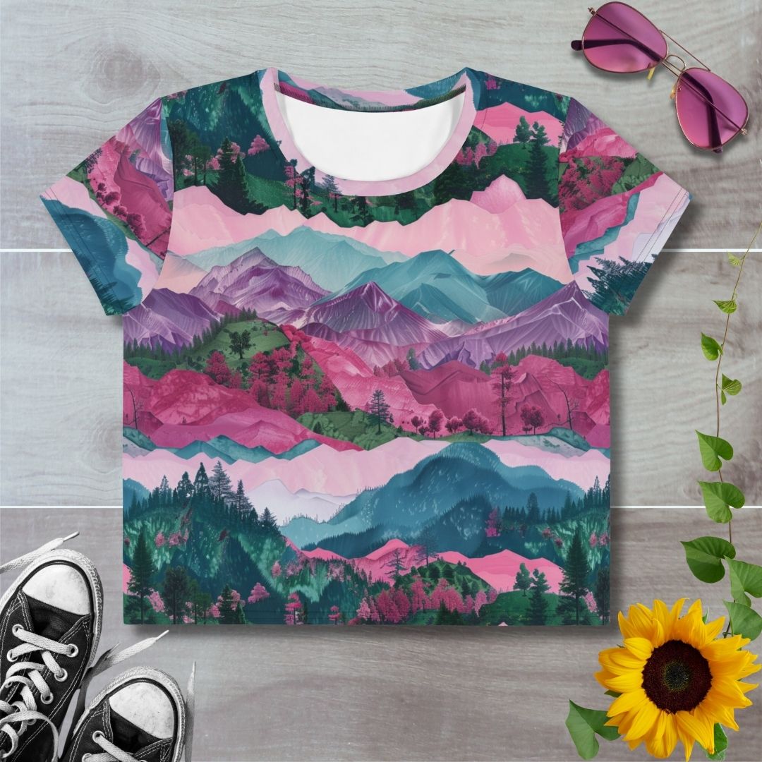 Women's all over print cropped t-shirt. Layered crimson, purple and teal hills, trees and mountains.