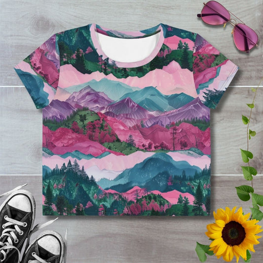 Women's all over print cropped t-shirt. Layered crimson, purple and teal hills, trees and mountains.