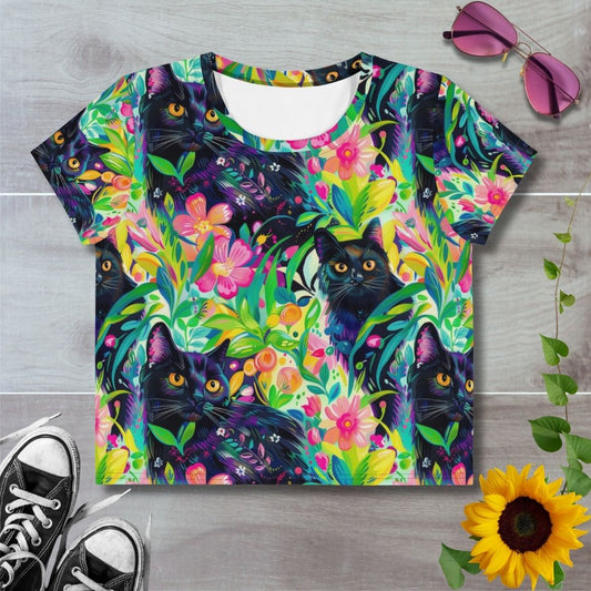 Women's all over print cropped t-shirt. Black cats hide in green grass and pink florals