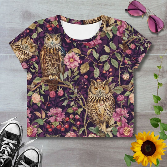 Women's all over print cropped t-shirt. Owls on branches with pink florals, red berries and purple background